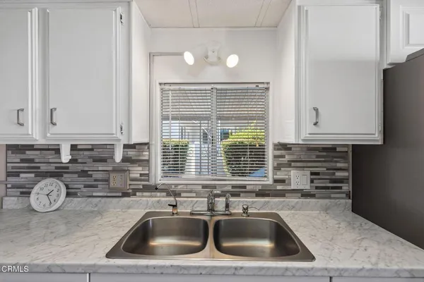 a kitchen with a sink cabinets and window
