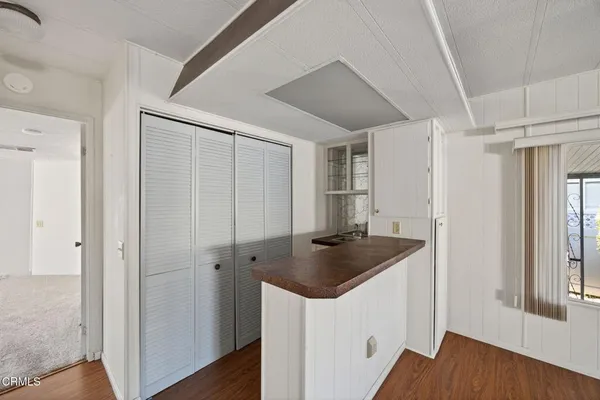 a kitchen with sink cabinets and wooden floor