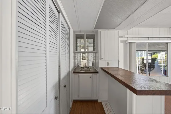 a kitchen with granite countertop a sink and cabinets