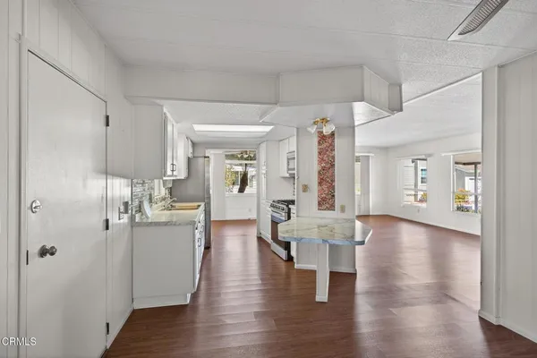 a view of a kitchen with a table and chairs