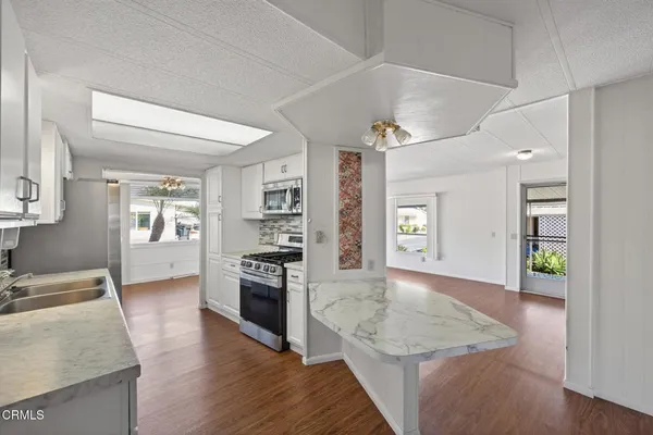 a kitchen with a stove and a wooden floors