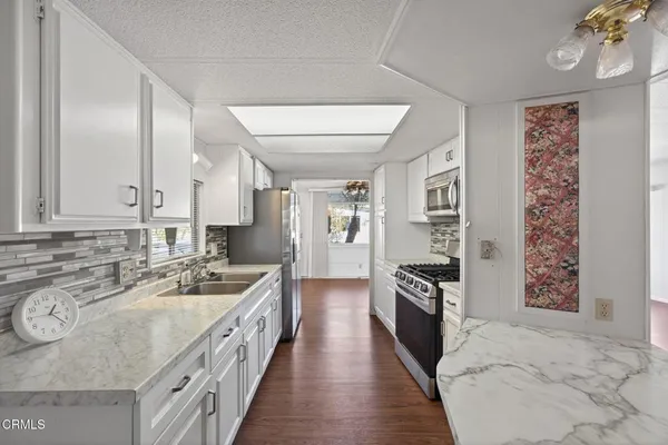 a large kitchen with a stove and refrigerator