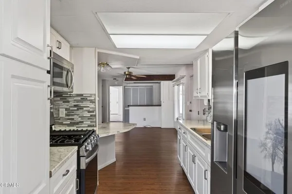 a kitchen with stainless steel appliances a refrigerator a stove a sink and dishwasher