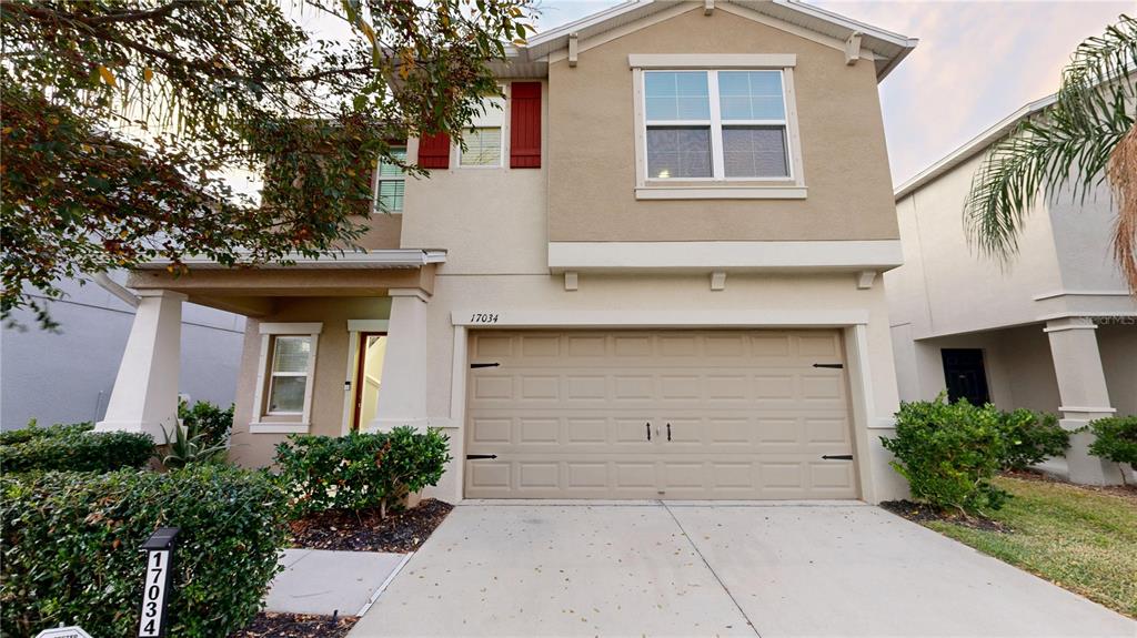 a front view of a house with garage