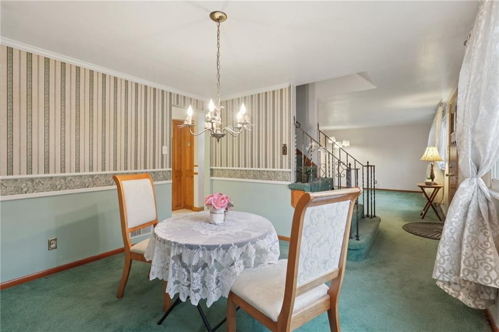 631 George Street Turtle Creek, PA 15145 - Photo 12 of 44 a view of a dining room with furniture window and wooden floor