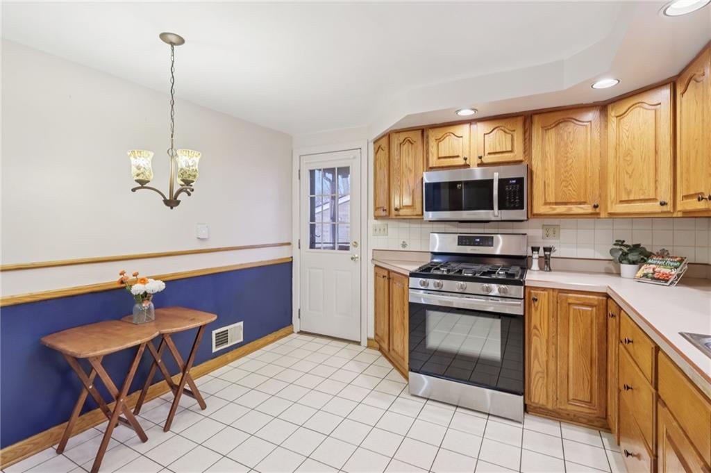 631 George Street Turtle Creek, PA 15145 - Photo 17 of 44 a kitchen with stainless steel appliances granite countertop a stove a sink dishwasher a microwave oven with granite countertops and cabinets