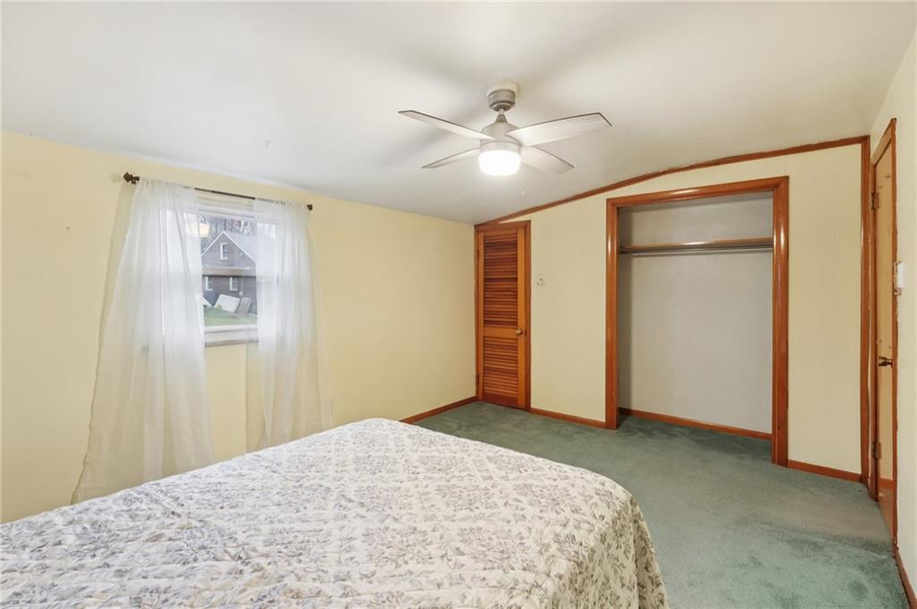 631 George Street Turtle Creek, PA 15145 - Photo 24 of 44 a bedroom with a large bed and a chandelier