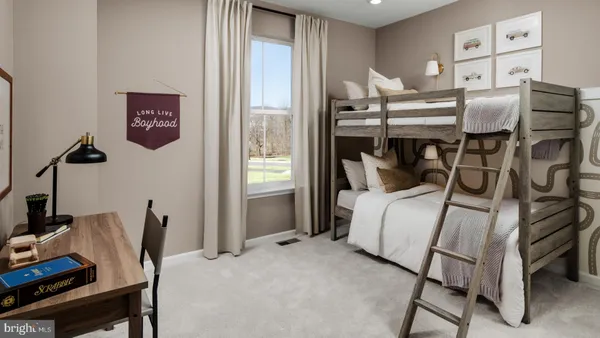 a bedroom with a bed and a desk