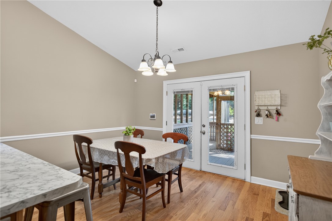 151 Towne Creek Trail Anderson, SC 29621 - Photo 12 of 49 Hardwood floors and vaulted ceilings elevate this charming dining area, offering direct access to an outdoor deck.
