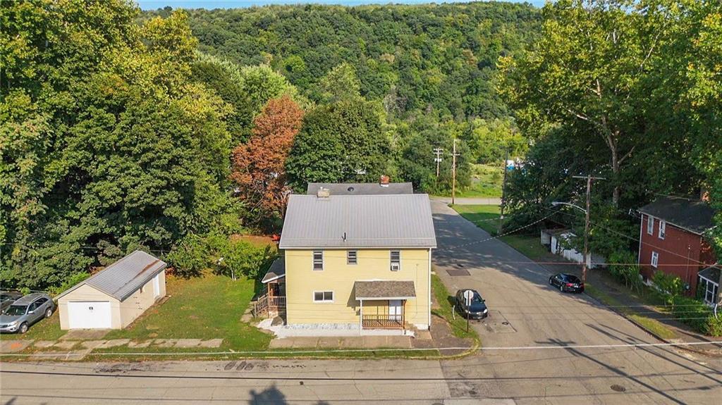 118 15th Street, Unit 1 Beaver Falls, PA 15010 - Photo 1 of 13 an aerial view of a house with yard and mountain view in back