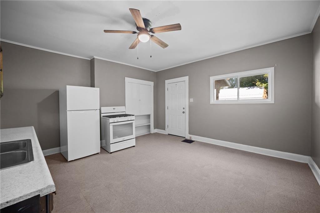 118 15th Street, Unit 1 Beaver Falls, PA 15010 - Photo 6 of 13 a view of a kitchen with a sink and a refrigerator