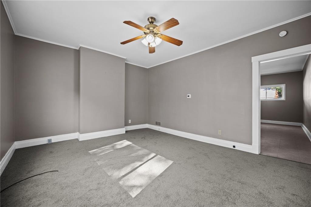 118 15th Street, Unit 1 Beaver Falls, PA 15010 - Photo 7 of 13 an empty room with closet and fan