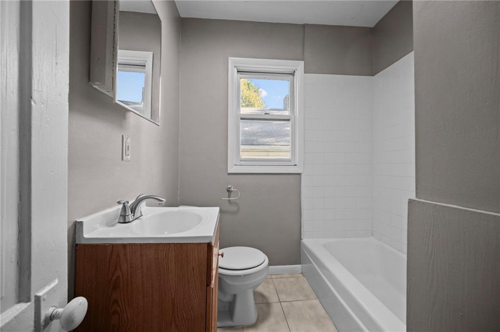 118 15th Street, Unit 1 Beaver Falls, PA 15010 - Photo 10 of 13 a bathroom with a sink toilet and shower