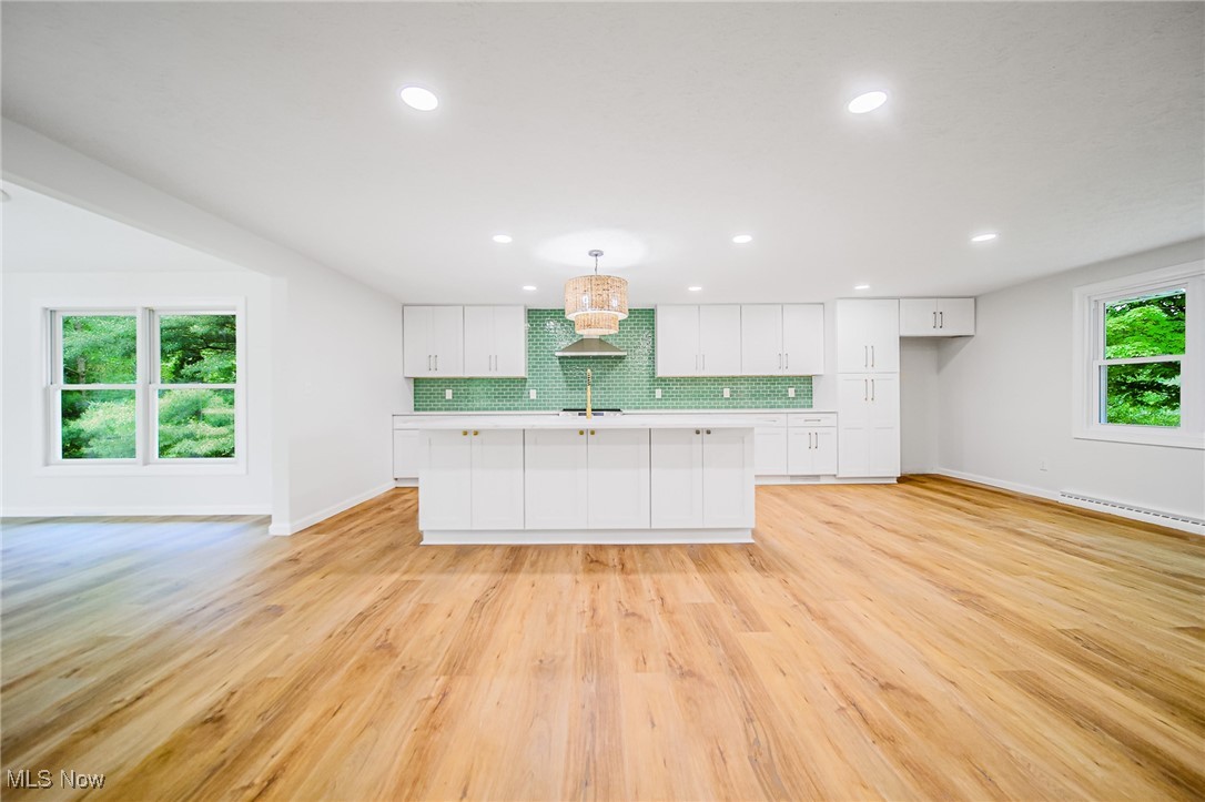 55 Elm Street Rittman, OH 44270 - Photo 10 of 46 Kitchen with a baseboard heating unit, baseboards, white cabinets, and recessed lighting