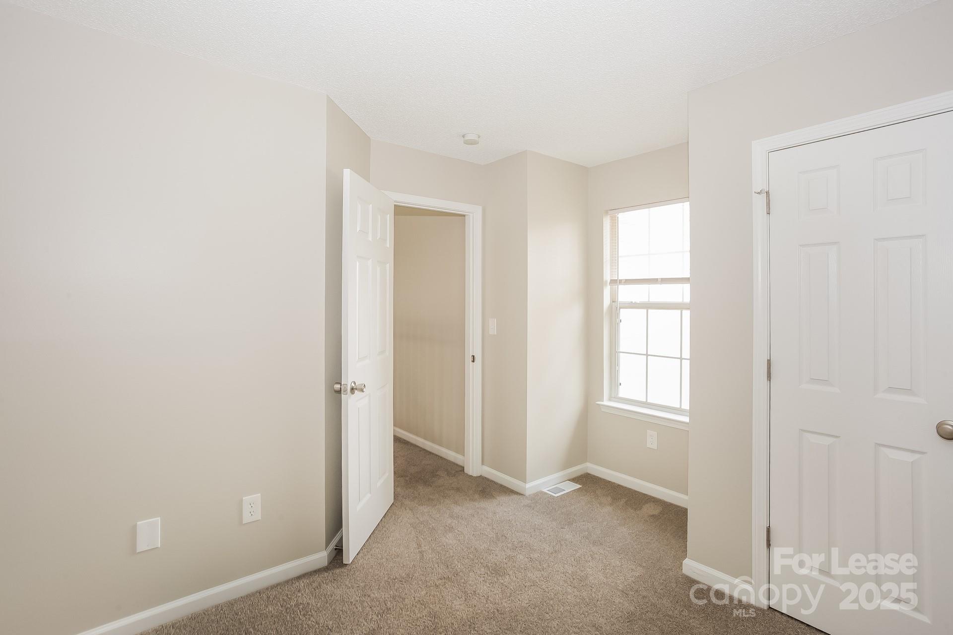 14319 Ruddy Court Charlotte, NC 28273 - Photo 12 of 16 an empty room with windows