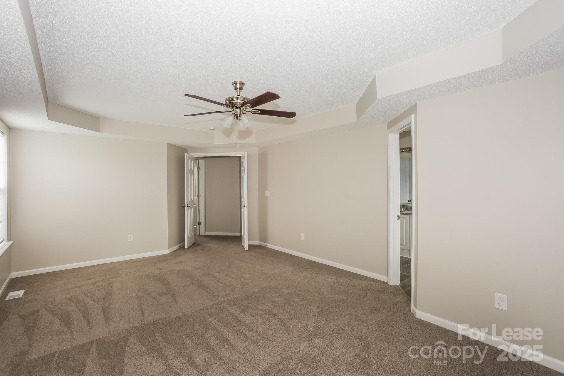 14319 Ruddy Court Charlotte, NC 28273 - Photo 7 of 16 a view of an empty room with a ceiling fan