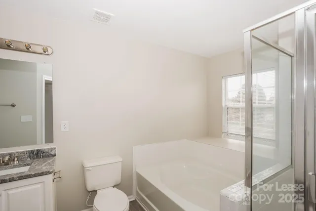 a white toilet sitting next to a bathroom sink