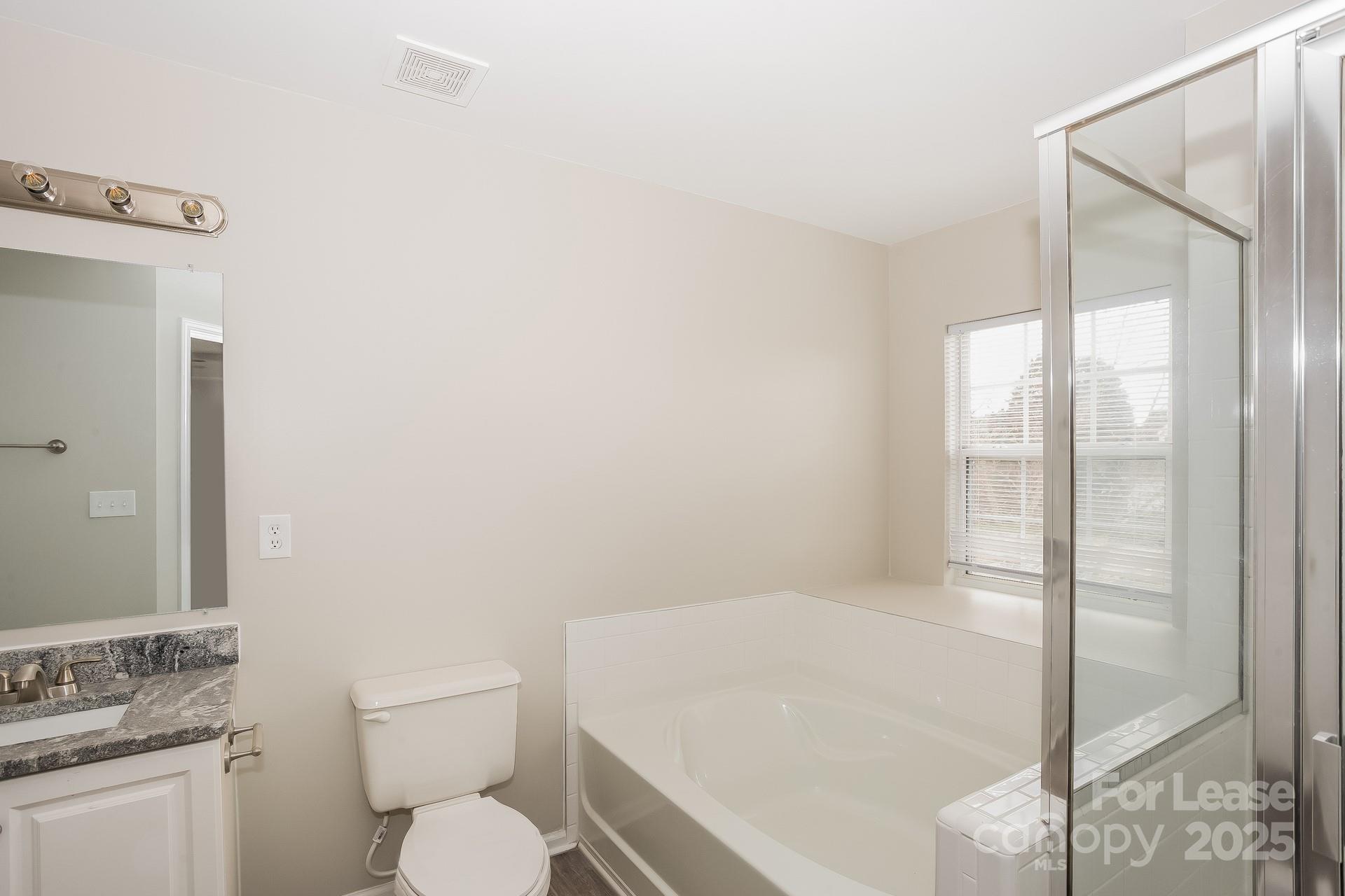 14319 Ruddy Court Charlotte, NC 28273 - Photo 8 of 16 a white toilet sitting next to a bathroom sink