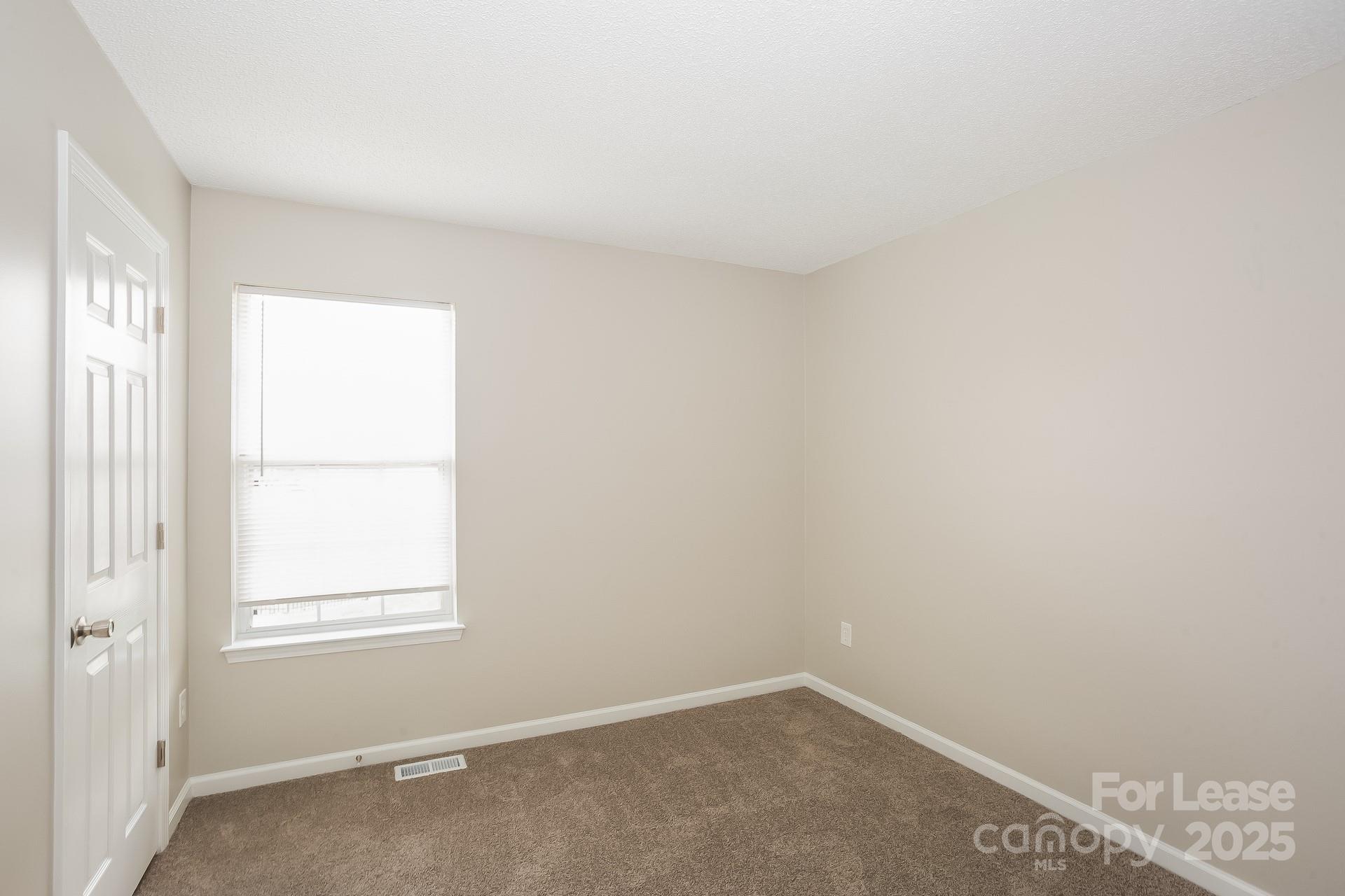14319 Ruddy Court Charlotte, NC 28273 - Photo 10 of 16 an empty room with windows