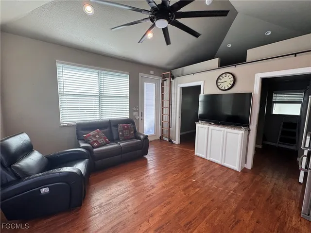 a view of a house with backyard and sitting area