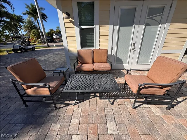 a view of a patio with table and chairs potted plants
