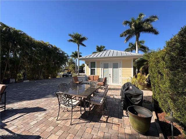 a view of a patio with table and chairs and potted plants