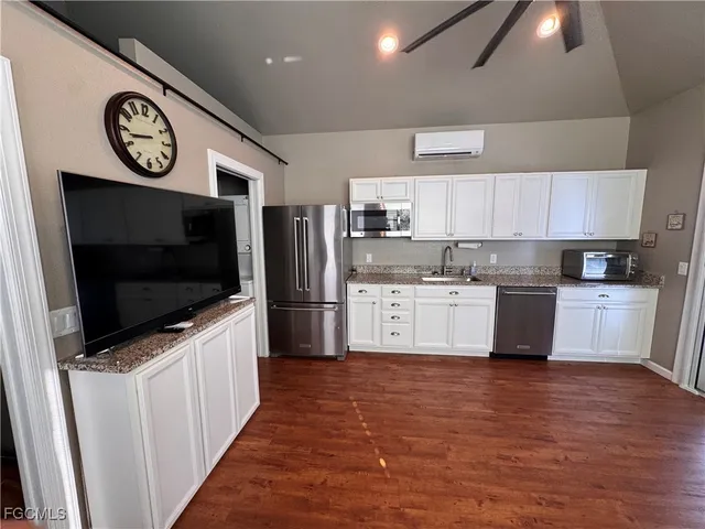 a kitchen with stainless steel appliances a refrigerator a stove top oven a sink and dishwasher