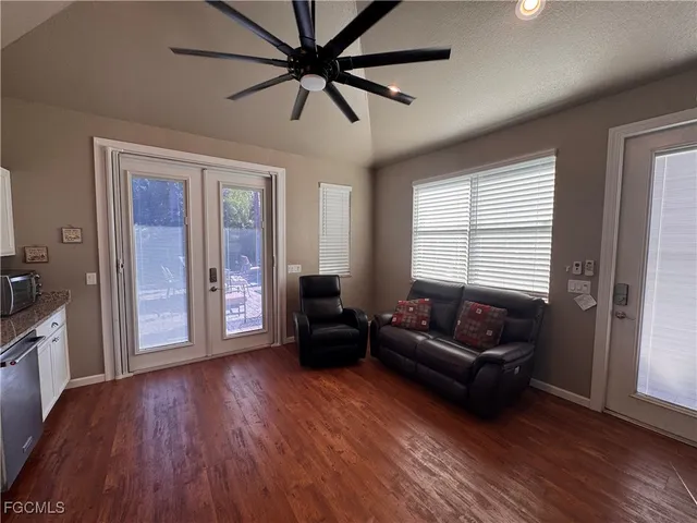 a living room with furniture and a wooden floor