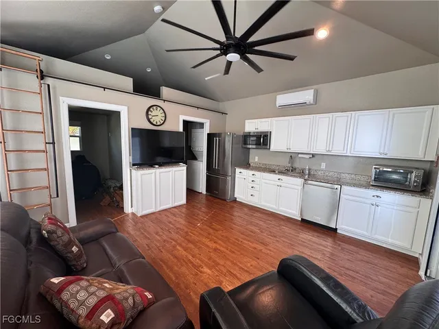 a living room with furniture and kitchen view