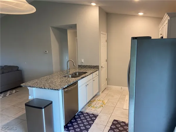 a kitchen with a sink and a refrigerator