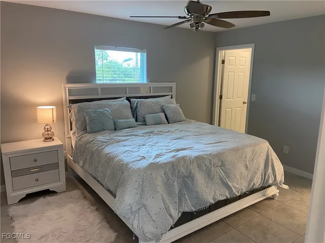 a bed sitting in a bedroom next to a window