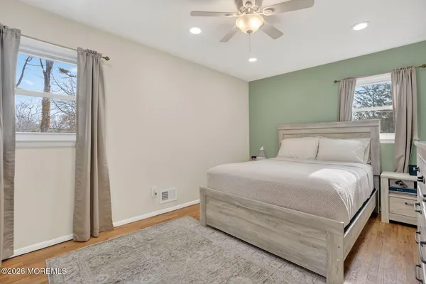 a bedroom with a large bed and a chandelier