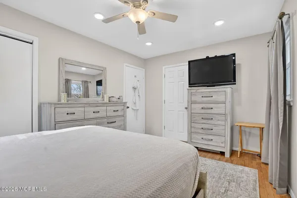 a bedroom with a large bed and a flat screen tv