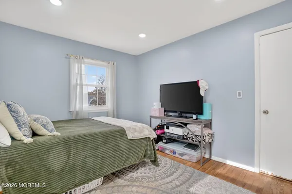 a bedroom with a bed and flat screen tv