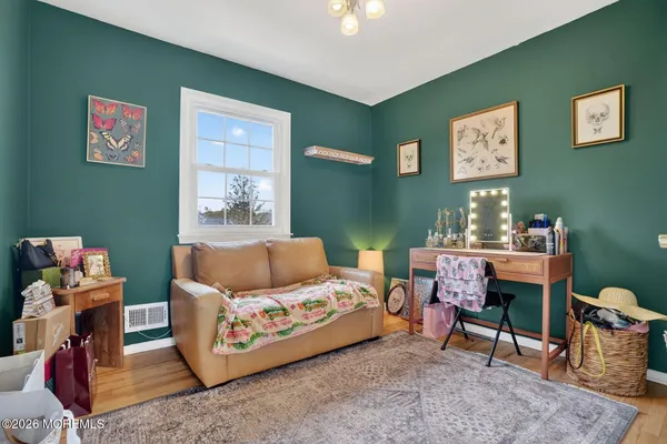 a bedroom with furniture and a lamp