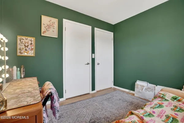 a bedroom with a bed and a dresser