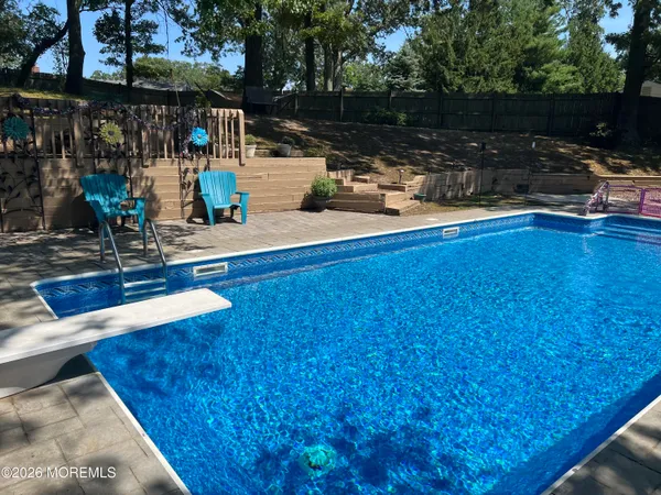 a view of a swimming pool with sitting area