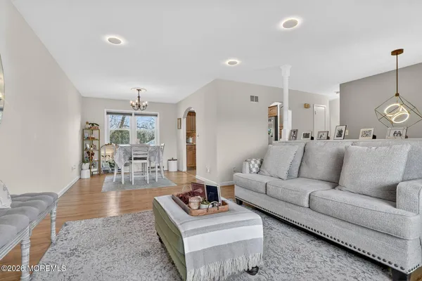 a living room with furniture and wooden floor
