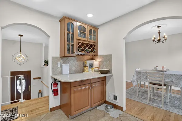 a view of a kitchen area with furniture and wooden floor
