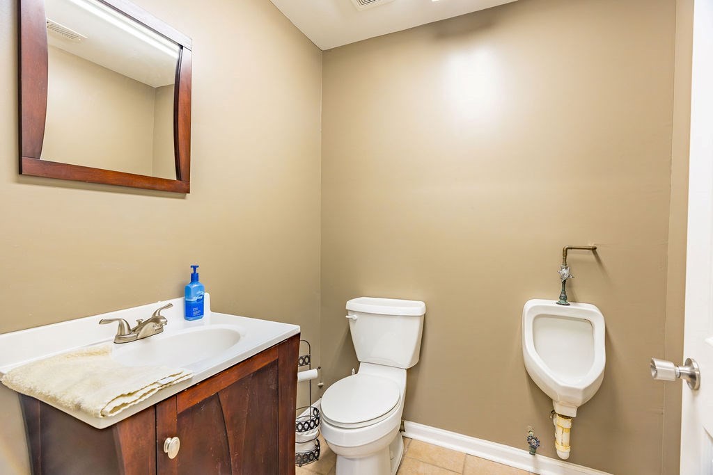 8496 South Madisonville Road Hopkinsville, KY 42240 - Photo 16 of 22 a bathroom with a sink a toilet and mirror