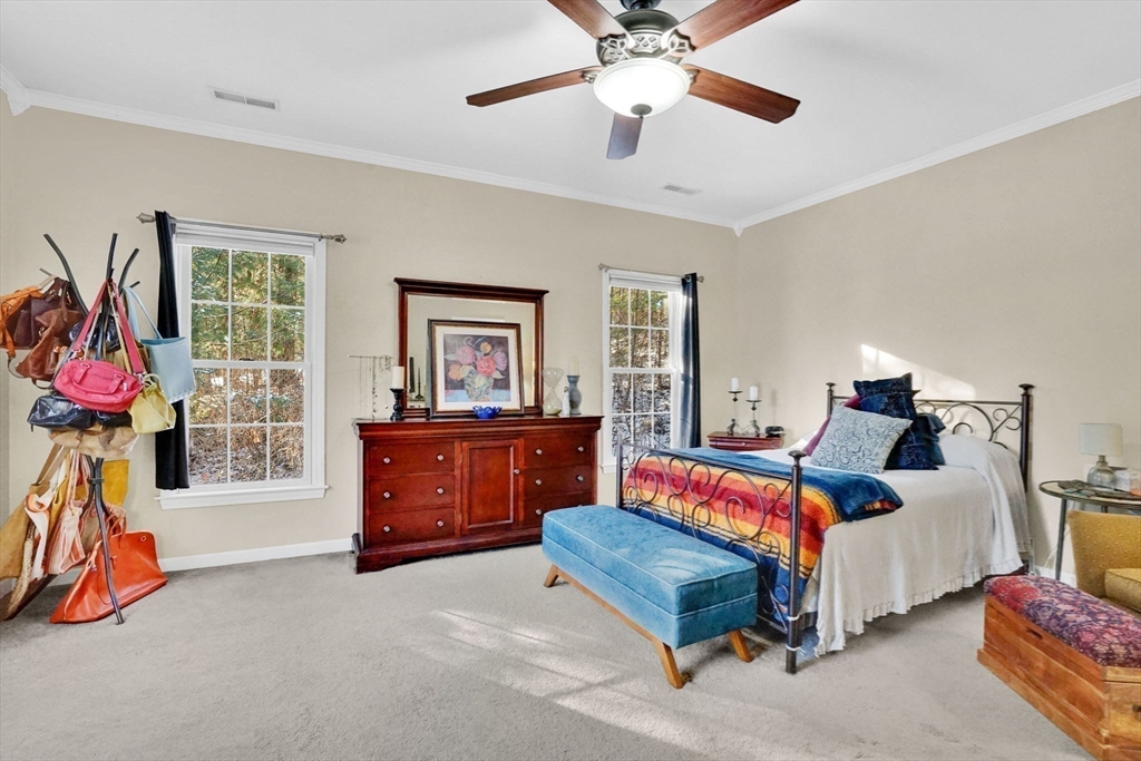 1 Pioneer Drive Palmer, MA 01069 - Photo 14 of 31 a bedroom with a bed and a chandelier