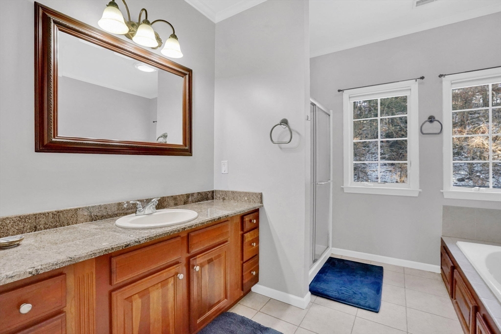1 Pioneer Drive Palmer, MA 01069 - Photo 16 of 31 a bathroom with a granite countertop sink a mirror and a window