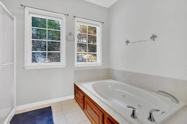 a bathroom with a tub and a window