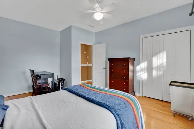a bedroom with a bed table and a closet