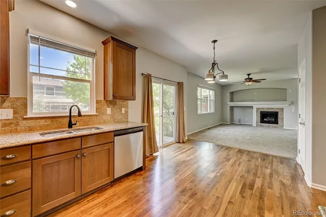 a view of an empty room with a fireplace and a window