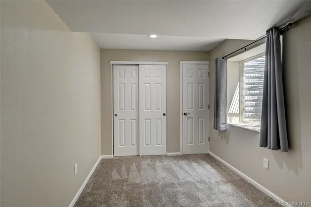 a view of a hallway with stairs and wooden floor