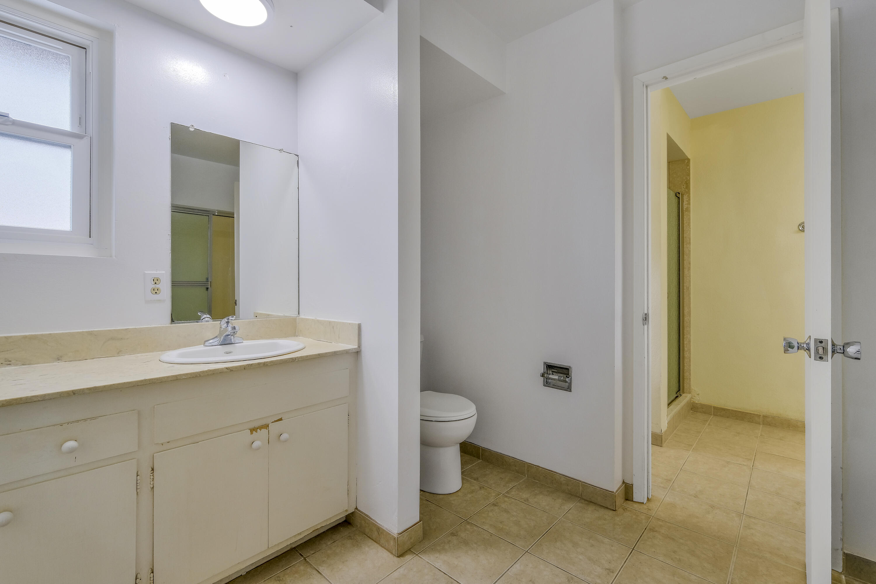 5376 Berkeley Road Santa Barbara, CA 93111 - Photo 11 of 18 a bathroom with a granite countertop sink a toilet and a mirror