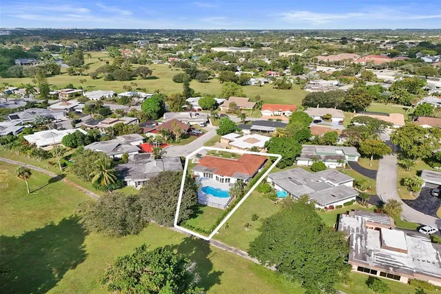 an aerial view of residential houses with outdoor space