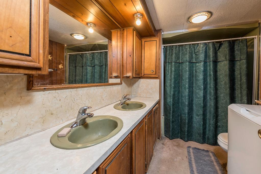 38285 North Sheridan Road, Unit 126 Beach Park, IL 60087 - Photo 11 of 17 a bathroom with a sink a toilet and a mirror