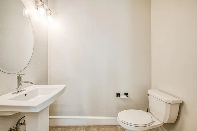 a kitchen with kitchen island granite countertop a table and chairs in it